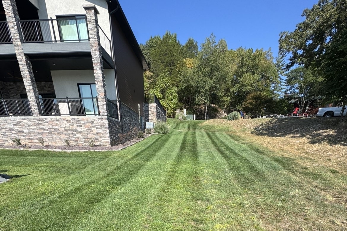 Striped lawn care beside a Lake-area home