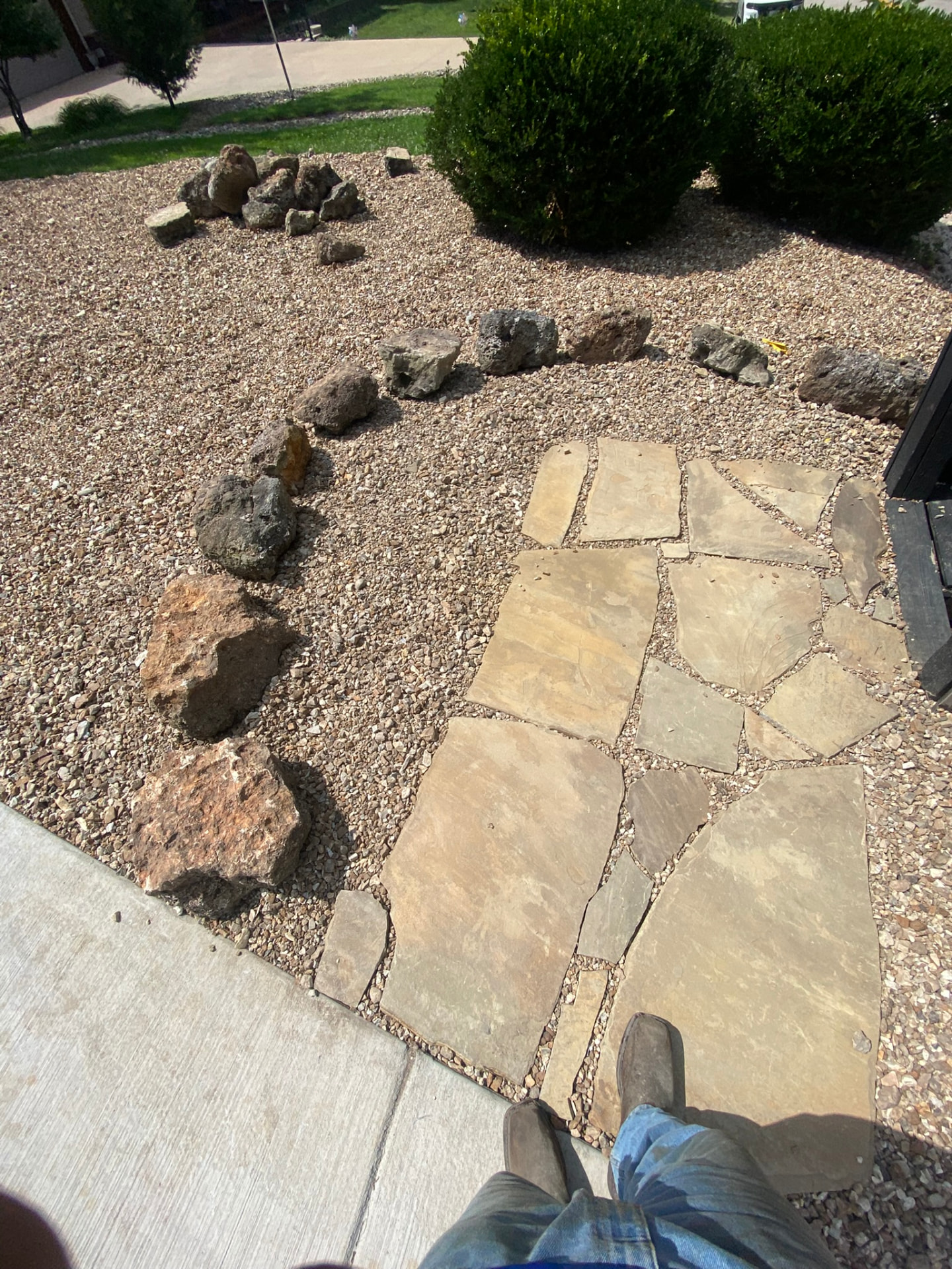 Flagstone walkway with river rock bed and boulder border